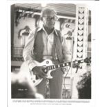 George Burns signed 10 x 8 inch b/w photo playing a guitar from Stg Peppers Lonely Hearts Club Band.