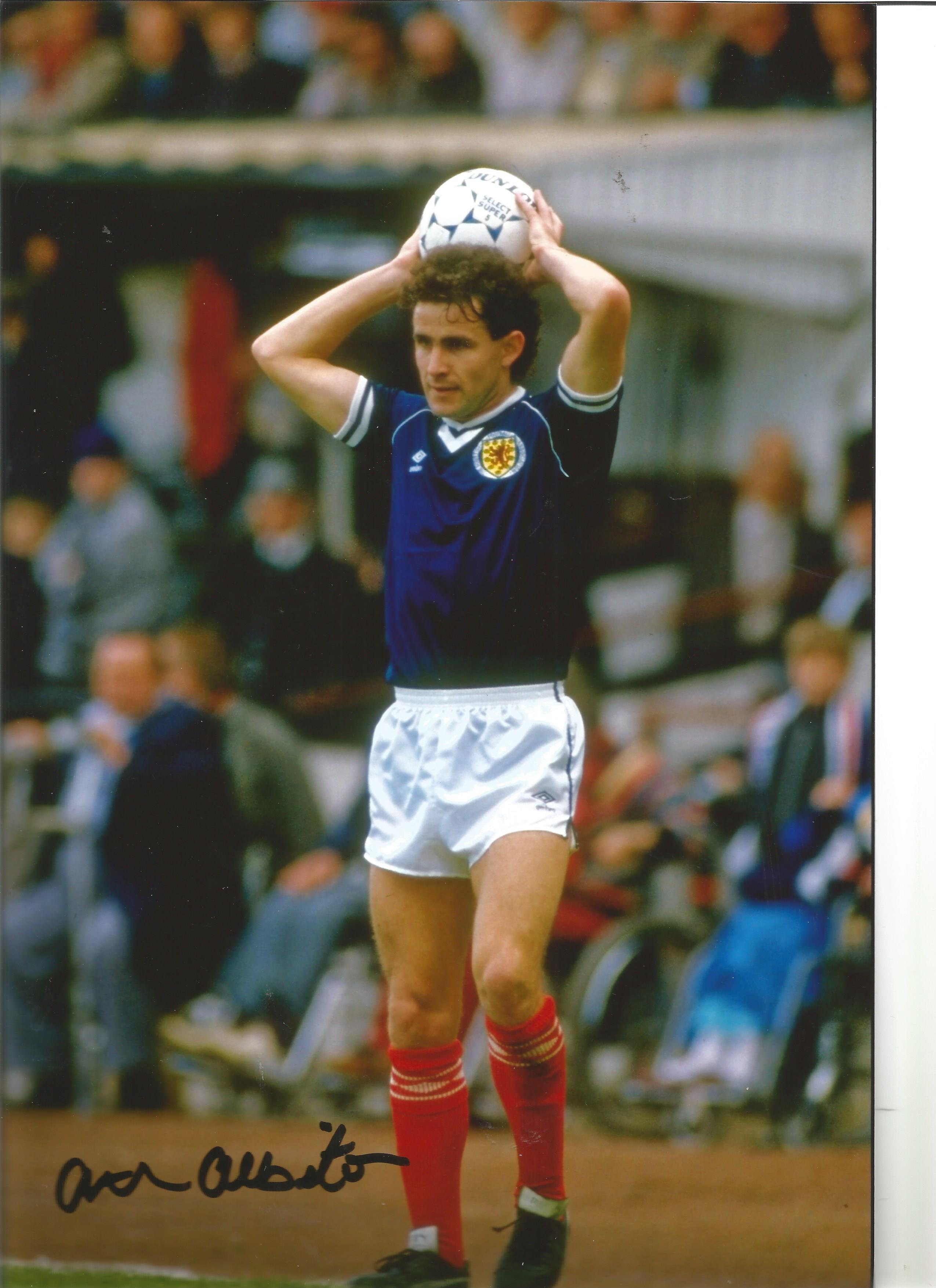 Football Arthur Albiston 12x8 Signed Colour Photo Pictured Playing For Scotland . Good Condition.