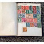 Stamp collection housed in miniature album contains world stamps from late 1800s to mid-1950s