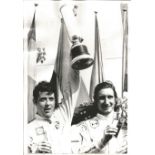 Motor racing Brian Redman 9x7 original press black and white photo pictured holding aloft the