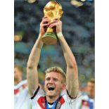 Football André Schurrle signed 16x12 colour photo pictured lifting the World Cup for Germany. Good