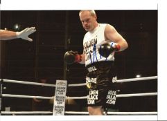 Uwe Boll signed 10 x 8 inch colour photo in boxing ring. Good Condition. All autographed items are