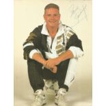 Paul Gascoigne signed 12 x 8 inch colour photo, casual pose sitting on football. Good Condition. All