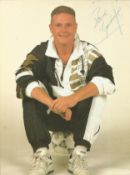 Paul Gascoigne signed 12 x 8 inch colour photo, casual pose sitting on football. Good Condition. All