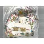 British Commonwealth stamp collection accumulation of stamps on paper in bag a lot of the items