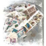 British Commonwealth stamp collection accumulation of stamps on paper in bag a lot of the items