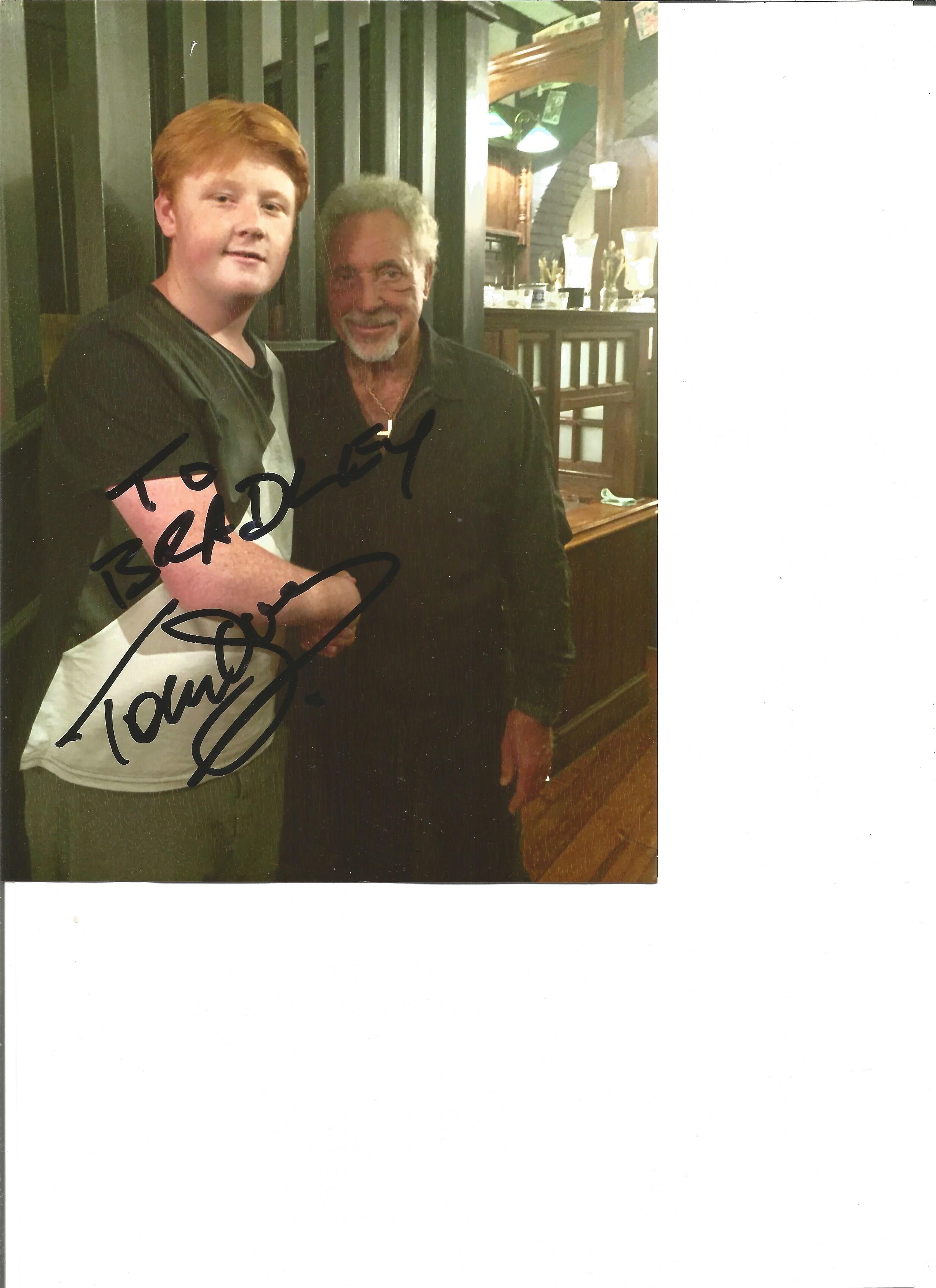 Tom Jones signed 8x6 colour photo. Dedicated to Bradley. Good Condition. All autographs are