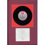 Ian Dury signature piece mounted below 45rpm vinyl record of Inbetweenies. Mounted and framed to