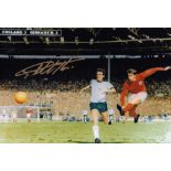 GEOFF HURST 1966: Autographed 12 x 8 photo, depicting GEOFF HURST slamming the ball into the