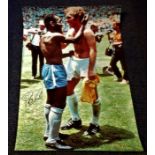 Football Pele signed 33x15 colour photo picturing the moment the iconic moment with Booby Moore