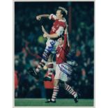 ARSENAL 1995: Autographed press issued 10 x 8 photo, dated 16, 12, 95, depicting LEE DIXON jumping