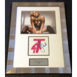 Pink signed T4 logo mounted and framed below colour photo of the singer. Approx overall size