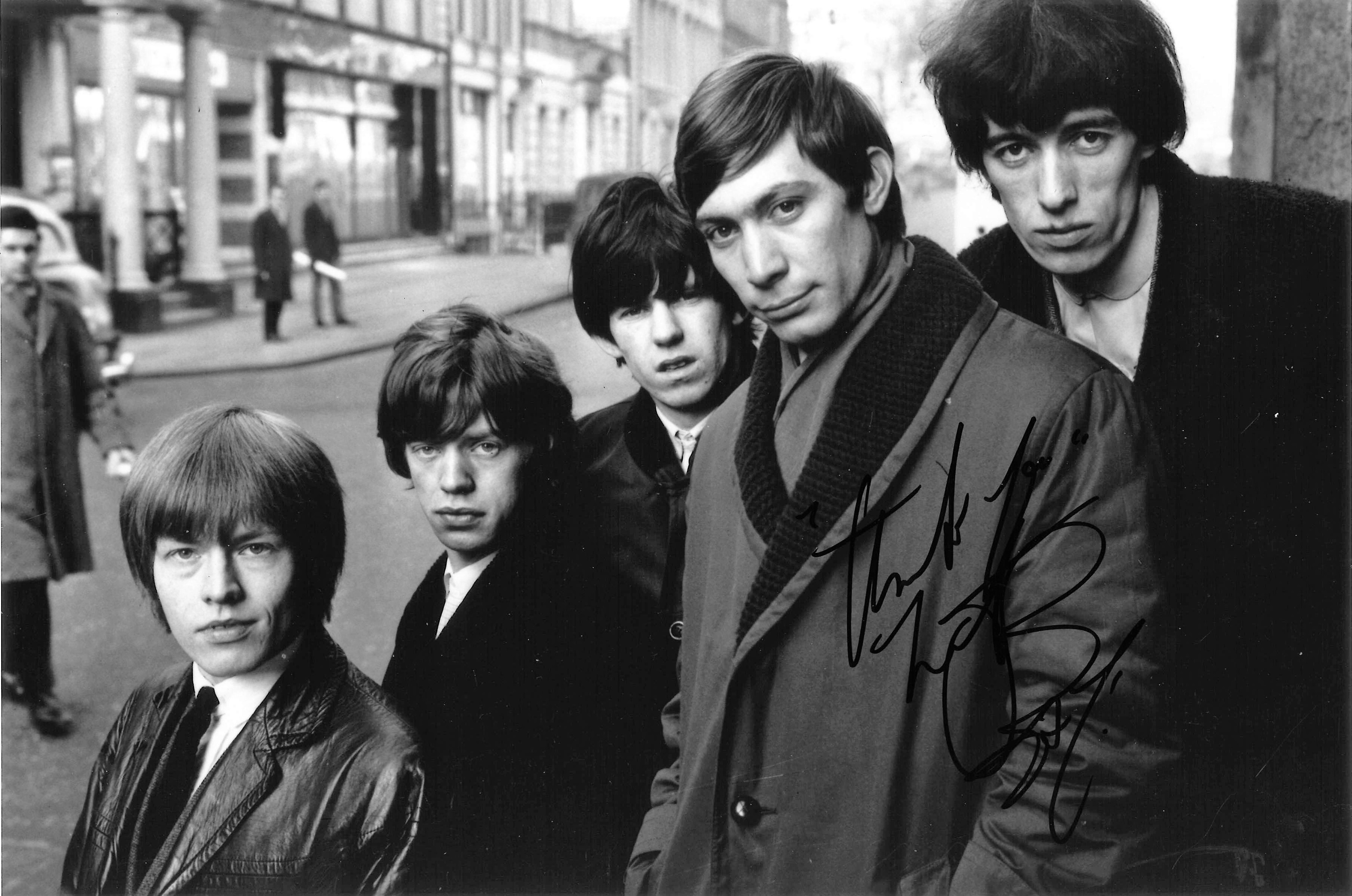 Charlie Watts signed 12x8 black and white photo pictured with his fellow Rolling Stones band