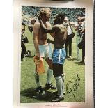 Pele signed 16 x 12 inch colour photo swapping shirt with Bobby Moore.
