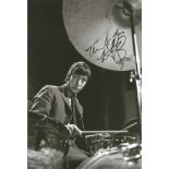 Charlie Watts signed 12x8 black and white photo. Slightly smudged, possible dedication removed.