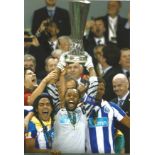 Helton Arruda signed 12x8 colour photo pictured lifting 2011 Europa League trophy for Porto. Good
