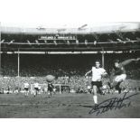 Football Geoff Hurst signed 12x8 black and white photo pictured scoring in the 1966 World Cup final.
