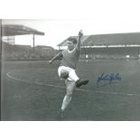 Johnny Giles signed 12x8 black and white photo pictured in his early playing days with Manchester