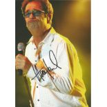 Huey Lewis signed12 x 8 inch colour photo on stage. All autographs come with a Certificate of