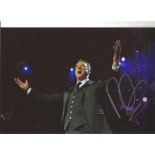 Russell Watson signed 12x8 colour photo of the singer performing on stage. All autographs come