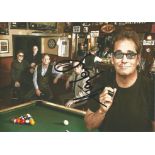 Huey Lewis signed12 x 8 inch colour photo with his band in a bar. All autographs come with a