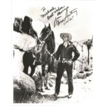 Gene Autry signed 10 x 8 inch b/w photo To Michael Best Wishes standing next to his horse. Condition