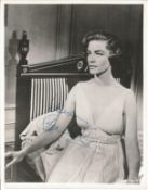 Lauren Bacall signed 10 x 8 inch vintage photo in low cut dress. Condition 8/10. All autographs come
