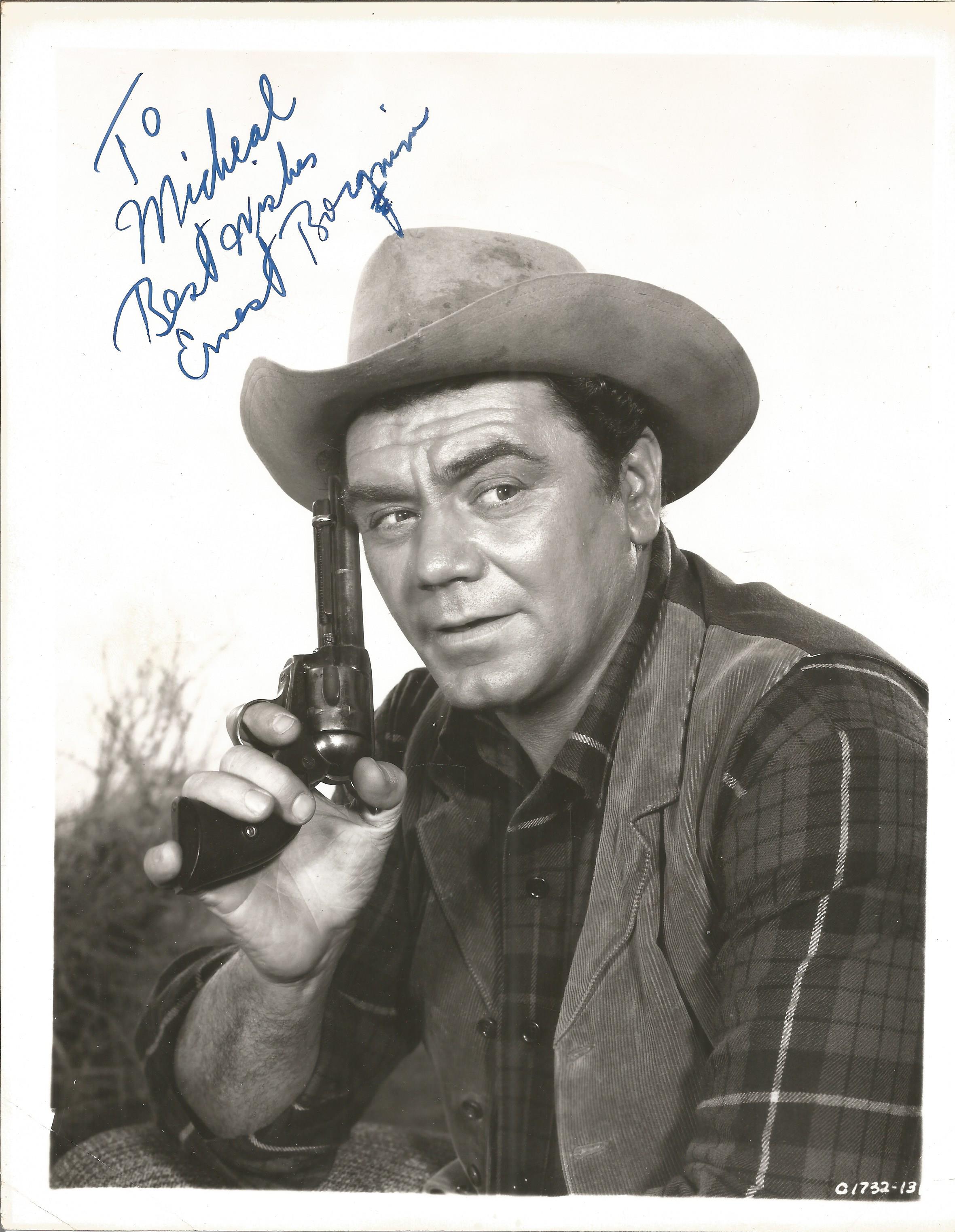 Ernest Borgnine signed 10 x 8 inch b/w portrait photo, to Michael. Young image western movie outfit.