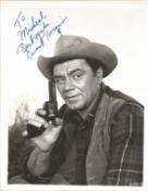 Ernest Borgnine signed 10 x 8 inch b/w portrait photo, to Michael. Young image western movie outfit.