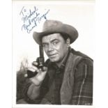 Ernest Borgnine signed 10 x 8 inch b/w portrait photo, to Michael. Young image western movie outfit.