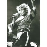 Kim Wilde signed 12 x 8 inch b/w photo singing on stage. Condition 8/10.
