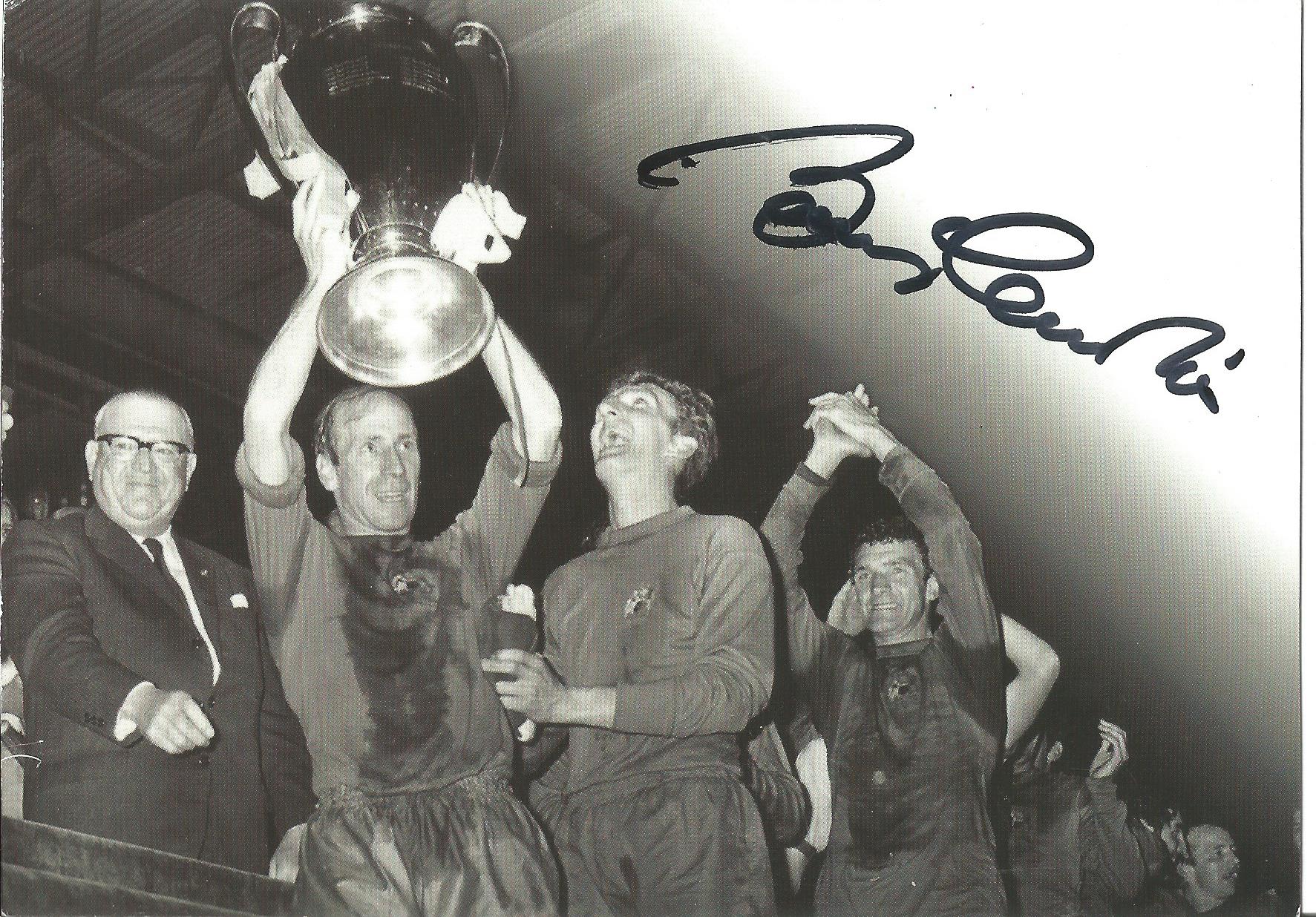 Football Bobby Charlton signed 6 x 4 inch b/w promo photo card holding up the European Cup.