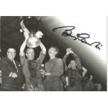 Football Bobby Charlton signed 6 x 4 inch b/w promo photo card holding up the European Cup.