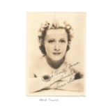 Irene Dunne signed 7 x 5 inch sepia photo dedicated, fixed to A4 page. Small nick to bottom RH