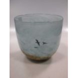 An art glass vase decorated with geese over landscape.