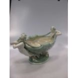 A late 19th Century Minton jadinere, green body of shell form supported by mermaids.