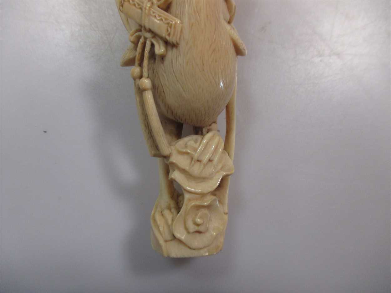 A late 19th century Japanese carved ivory figure of a girl playing a sho and seated on the back of a - Image 2 of 3