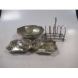 An Edwardian silver mounted tortoiseshell letter opener, a silver four bar toast rack, a bowl, a