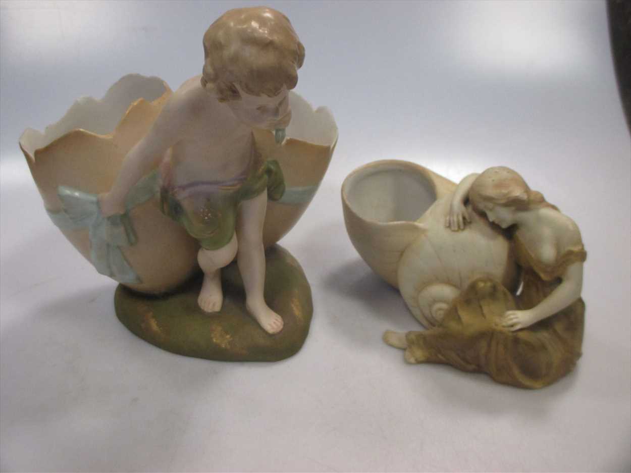 A Royal Vienna porcelain figure of a boy dragging a shell and another