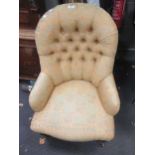 A Victorian button back nursing chair on turned legs and casters, and a carved wood long stool,