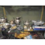 A collection of silver plated ware including flatware, a chamber stick, tea and coffee pots,