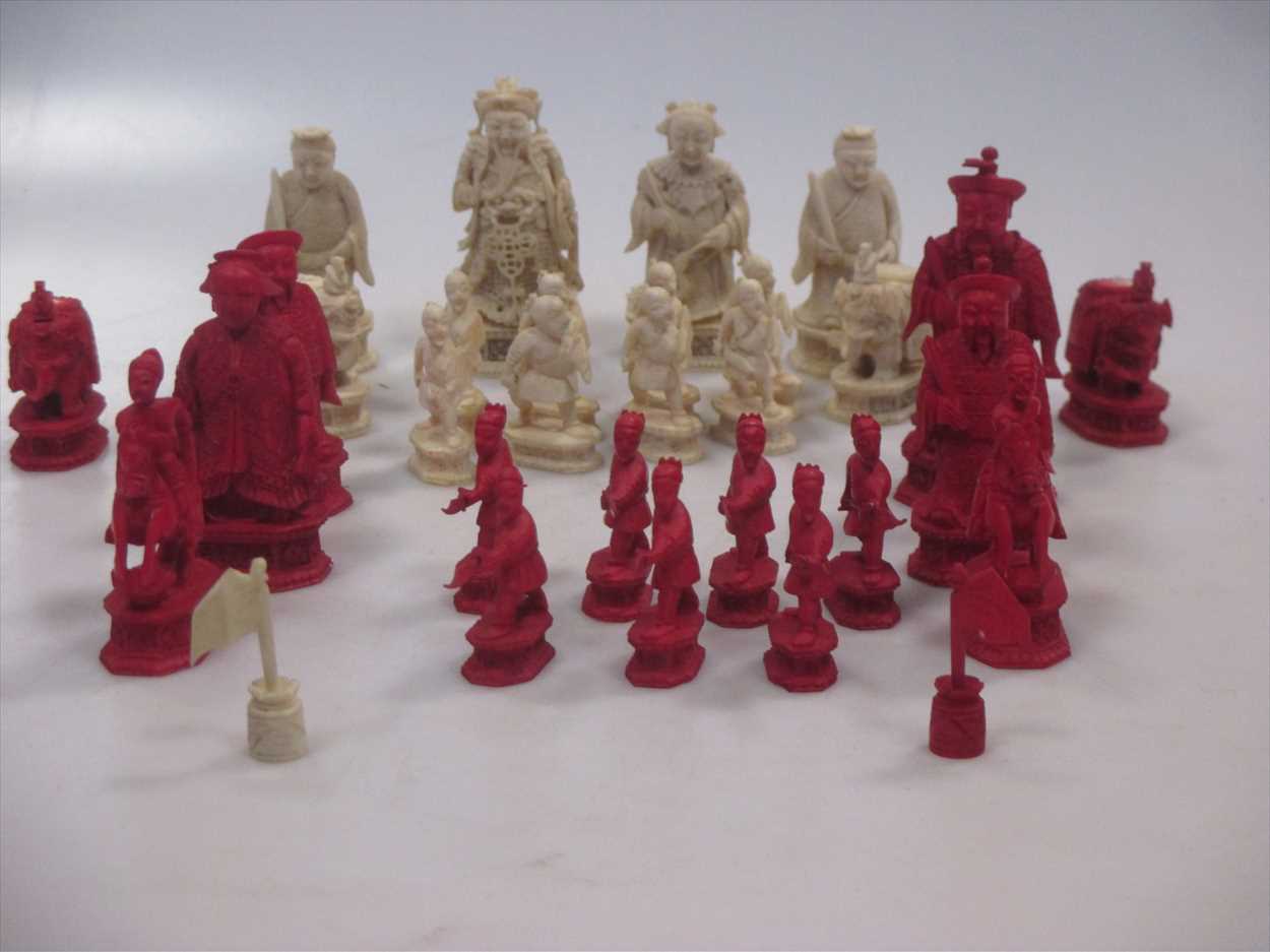 An early 19th century Cantonese carved ivory chess set to include fifteen red and fourteen white