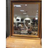 A moder Italian style ebonised and gilt rectangular ‘picture frame’ wall mirror