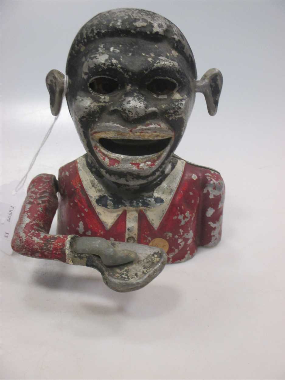 An antique automaton money box in the form of a negro with moving arm, mouth and eyes