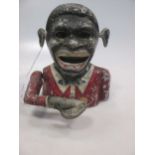 An antique automaton money box in the form of a negro with moving arm, mouth and eyes