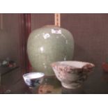 A Celadon oval jar, lacking lid, 22cm high together with two Nankin cargo type Chinese bowls (3)