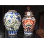 A 20th century Persian vase (damaged) and an Imari vase and cover (2)