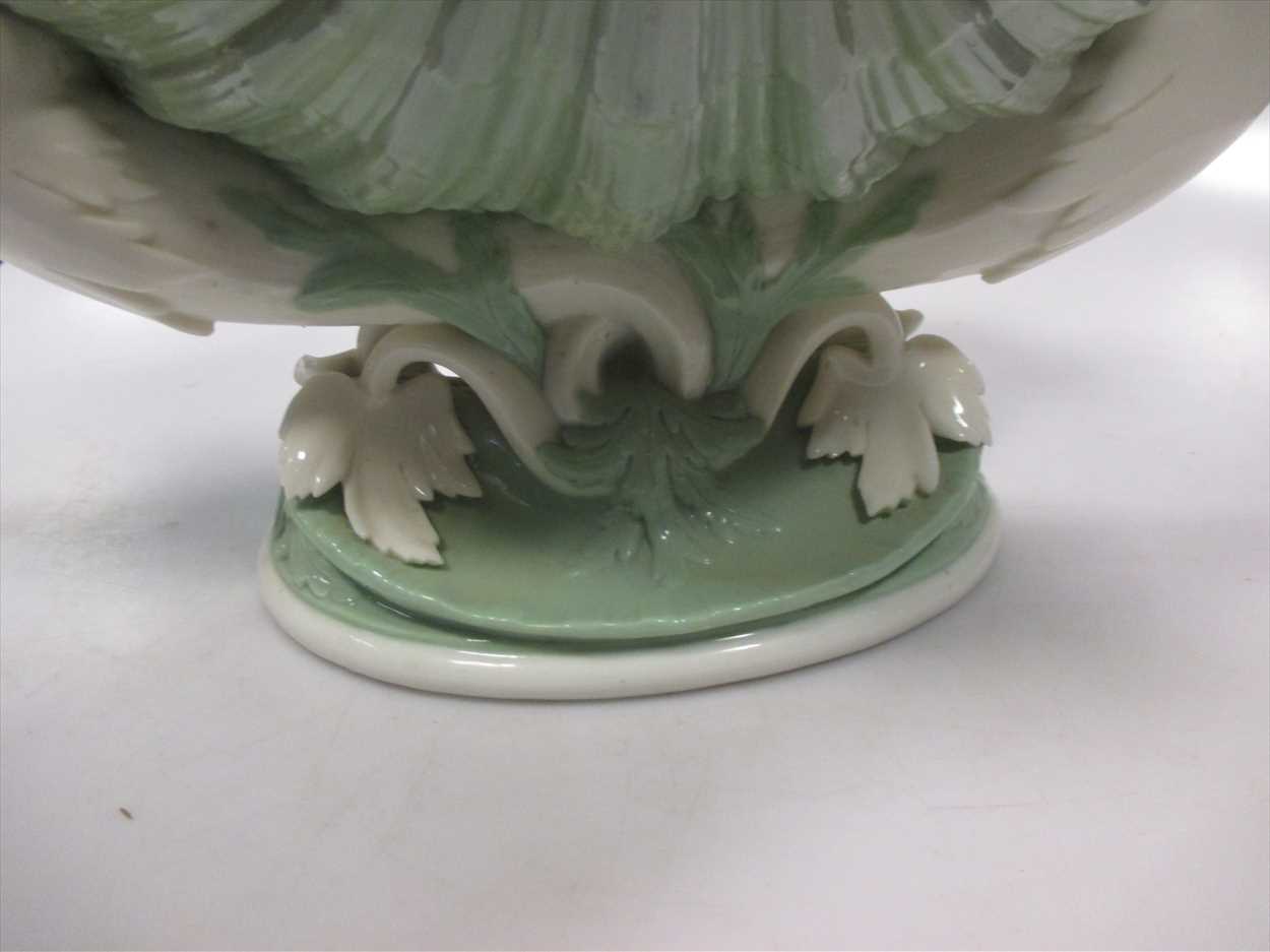 A late 19th Century Minton jadinere, green body of shell form supported by mermaids. - Image 2 of 2