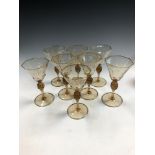 MVM Cappellin, Murano, a set of eight amber glass wine glasses, circa 1925,