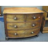 A George III mahogany bow fronted small chest of two short and two long drawers, with turned knob